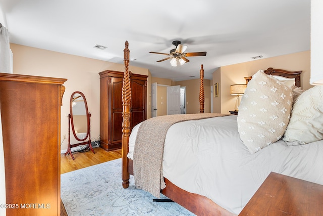 bedroom with visible vents, ceiling fan, and wood finished floors