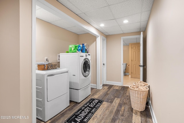 laundry area featuring laundry area, washing machine and dryer, baseboards, recessed lighting, and dark wood-type flooring