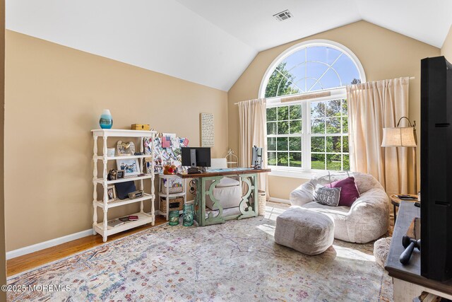 interior space with baseboards, a wealth of natural light, and lofted ceiling