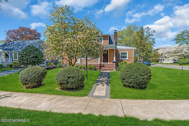 4 W Lake Rd, Red Bank, NJ 07701 - view of front of house with a chimney, a front lawn, and covered porch