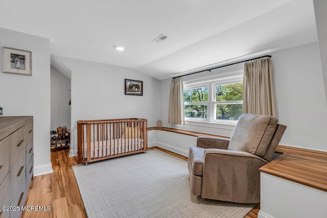 4 W Lake Rd, Red Bank, NJ 07701 - bedroom featuring light wood-style flooring, lofted ceiling, baseboards, and a nursery area