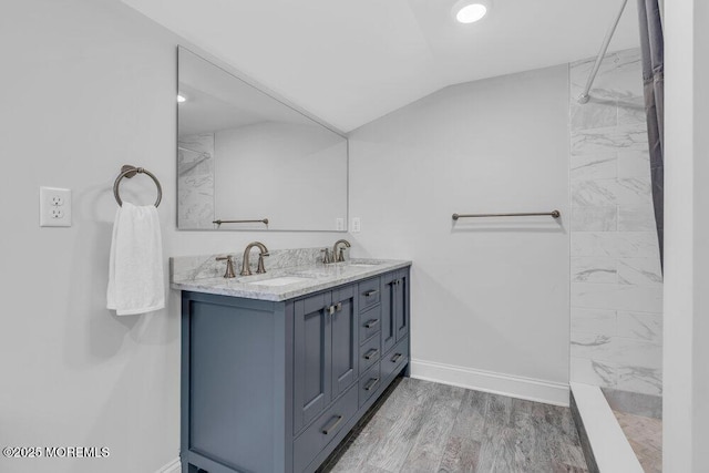4 W Lake Rd, Red Bank, NJ 07701 - bathroom featuring vaulted ceiling, baseboards, a shower, double vanity, and wood finished floors