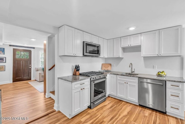 4 W Lake Rd, Red Bank, NJ 07701 - kitchen with appliances with stainless steel finishes, a sink, light wood-style flooring, white cabinets, and recessed lighting