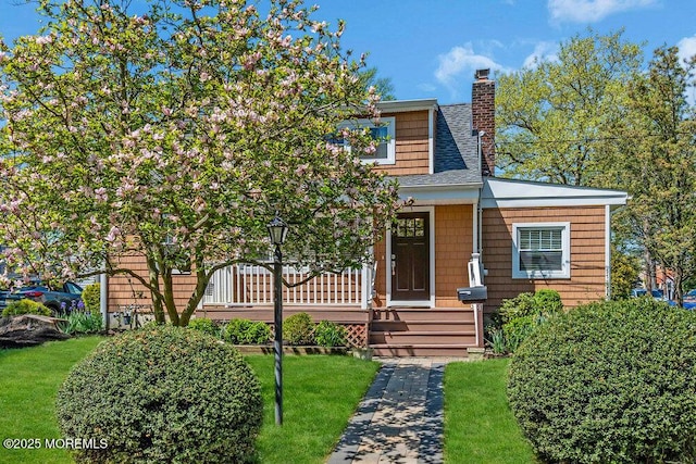 4 W Lake Rd, Red Bank, NJ 07701 - view of front of home with a chimney, covered porch, roof with shingles, and a front lawn