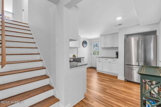 4 W Lake Rd, Red Bank, NJ 07701 - kitchen featuring appliances with stainless steel finishes, light stone counters, white cabinets, and light wood-style flooring
