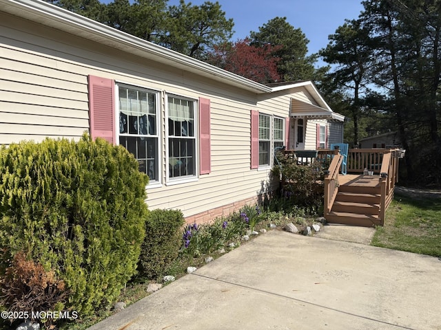 view of home's exterior featuring a deck and a patio
