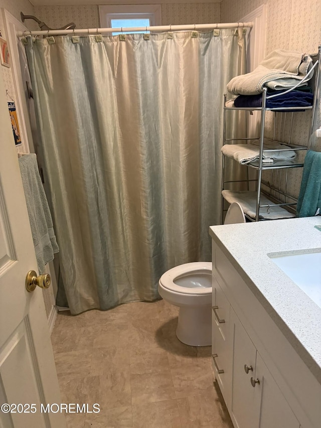 full bath with wallpapered walls, toilet, curtained shower, and vanity