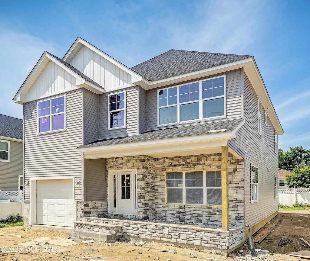 74 Manchester Ave, Keyport, NJ 07735 - view of front of house with a garage, stone siding, and a shingled roof