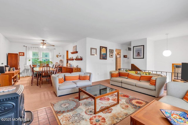 living area with ceiling fan and light tile patterned floors