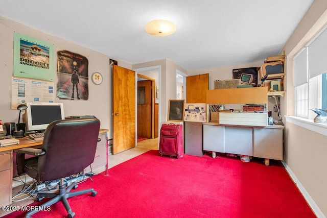 carpeted home office featuring baseboards
