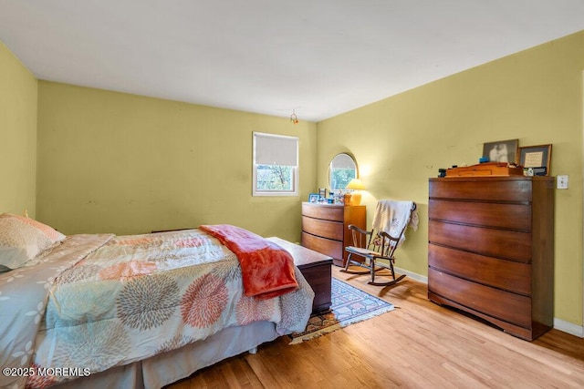 bedroom featuring wood finished floors and baseboards