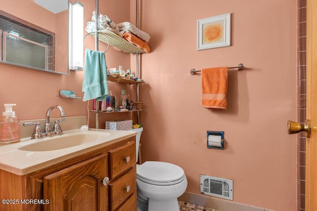 bathroom featuring toilet and vanity