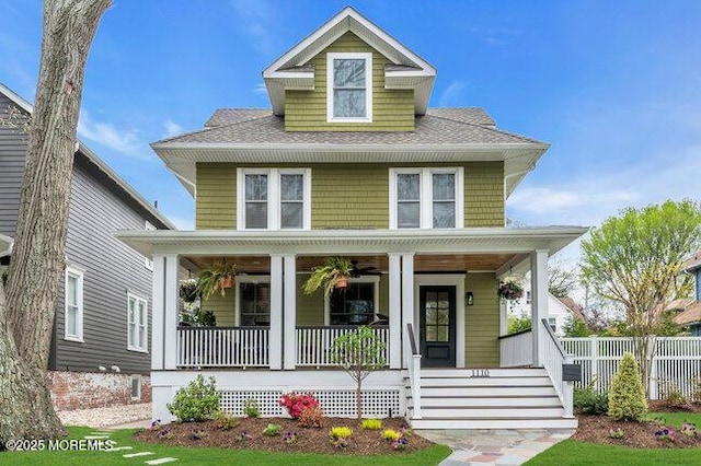 traditional style home featuring a shingled roof and covered porch
