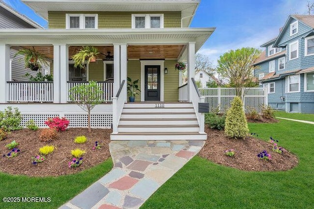 doorway to property featuring a porch and a lawn