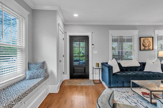 foyer with baseboards, ornamental molding, recessed lighting, and wood finished floors