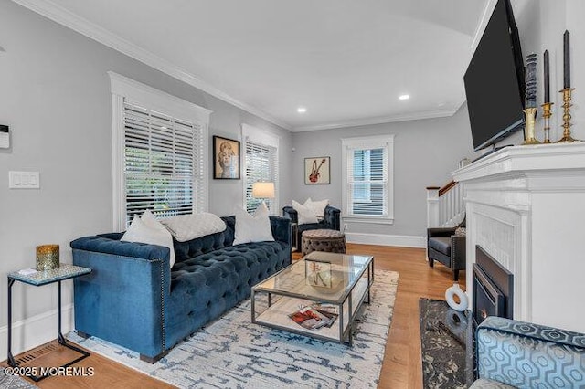 living area with recessed lighting, ornamental molding, and wood finished floors
