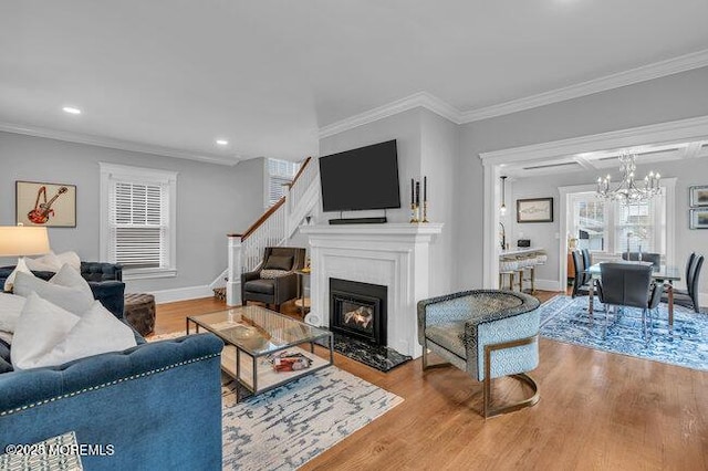 living area featuring crown molding, recessed lighting, stairs, and wood finished floors