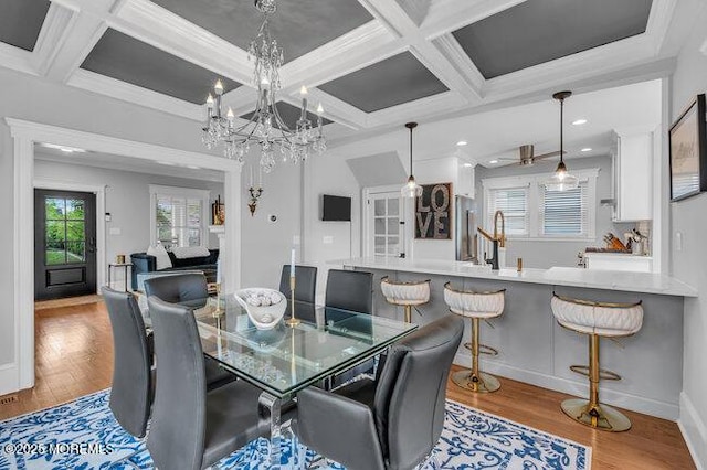 dining area with an inviting chandelier, beam ceiling, recessed lighting, wood finished floors, and coffered ceiling