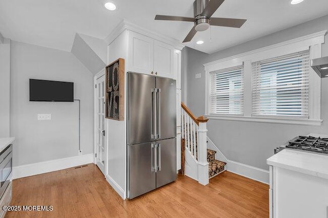 kitchen with recessed lighting, baseboards, high quality fridge, and white cabinetry