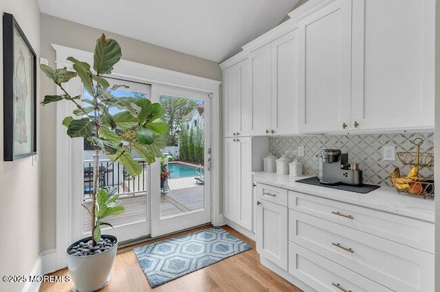 doorway to outside with light wood-style floors