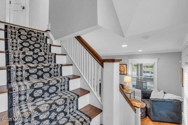 staircase with ornamental molding, recessed lighting, and wood finished floors