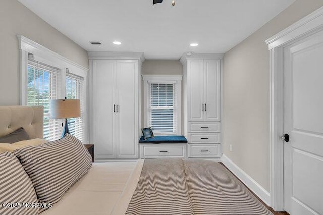 bedroom with baseboards, recessed lighting, and visible vents