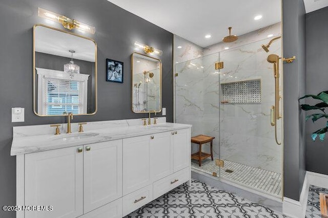 full bath featuring double vanity, recessed lighting, a marble finish shower, and a sink