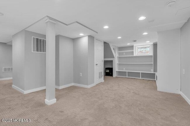basement featuring recessed lighting, baseboards, visible vents, and light carpet