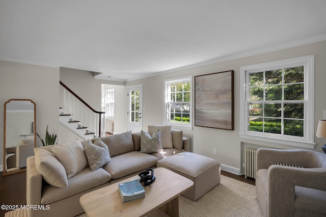 living area featuring stairway, baseboards, ornamental molding, and wood finished floors