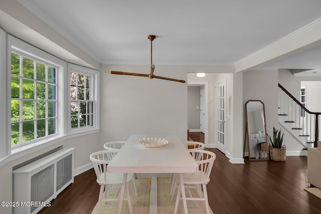 dining room featuring ornamental molding, baseboards, radiator heating unit, stairway, and dark wood-type flooring