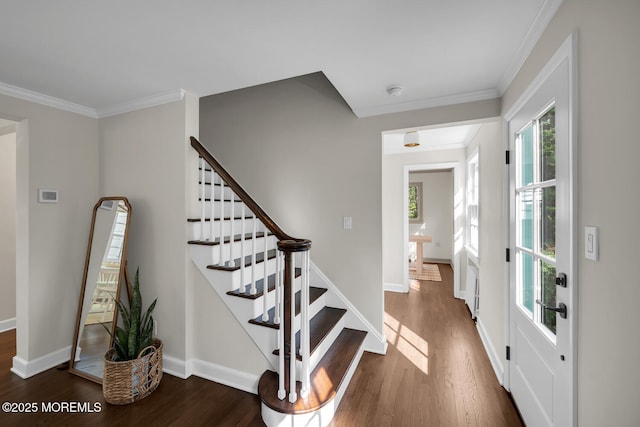 interior space with crown molding, stairs, baseboards, and wood finished floors