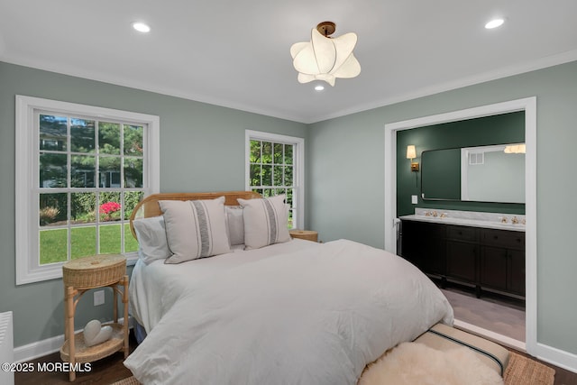 bedroom featuring baseboards, recessed lighting, and connected bathroom
