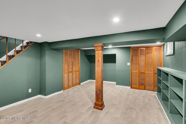 finished below grade area with recessed lighting, baseboards, stairway, and light wood finished floors