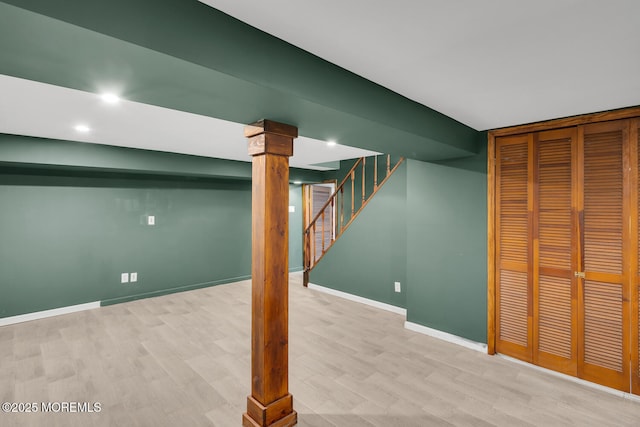 finished below grade area with baseboards, recessed lighting, wood finished floors, and stairway