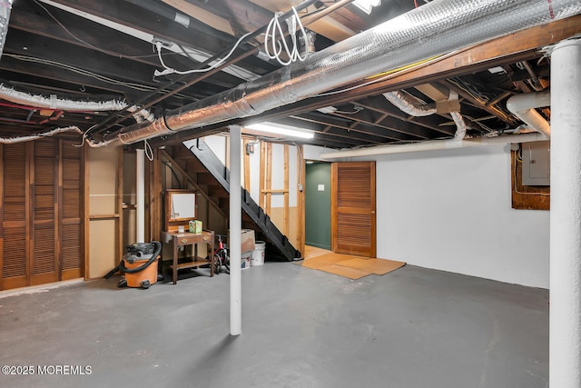 unfinished below grade area with stairway and electric panel