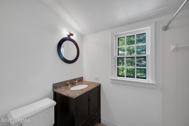 full bathroom featuring vanity, toilet, and tiled shower