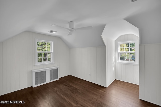 additional living space with ceiling fan, visible vents, a wealth of natural light, and radiator heating unit
