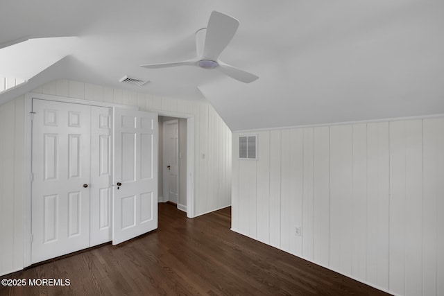 additional living space featuring visible vents, a ceiling fan, lofted ceiling, and dark wood-style floors