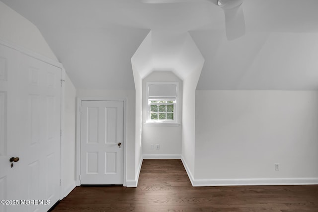 bonus room featuring baseboards, lofted ceiling, and dark wood-type flooring