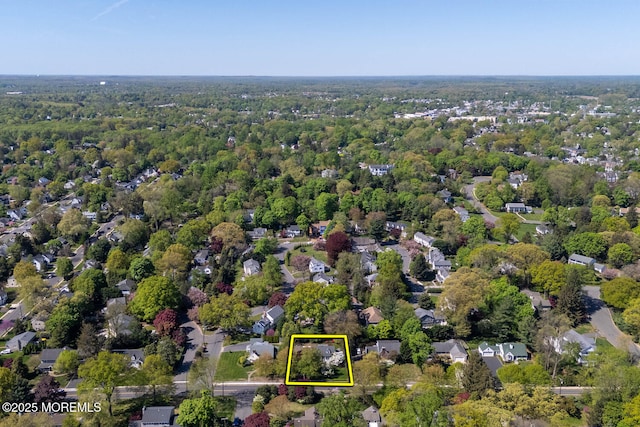 drone / aerial view featuring a wooded view