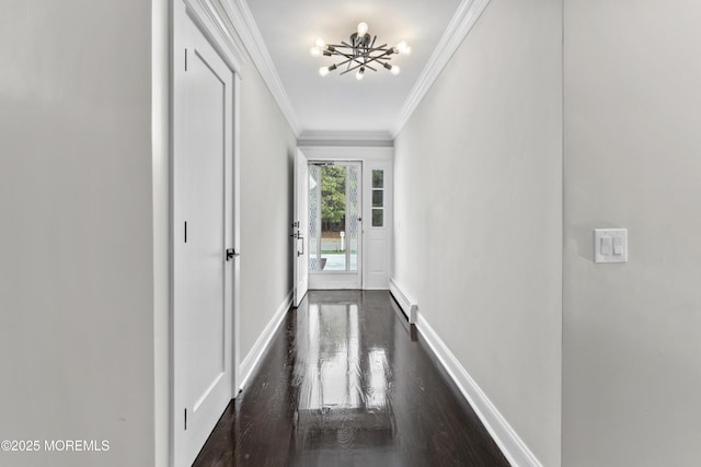 corridor featuring baseboards, a baseboard heating unit, an inviting chandelier, ornamental molding, and dark wood-type flooring