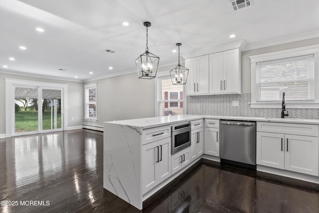kitchen featuring a notable chandelier, appliances with stainless steel finishes, a peninsula, recessed lighting, and visible vents