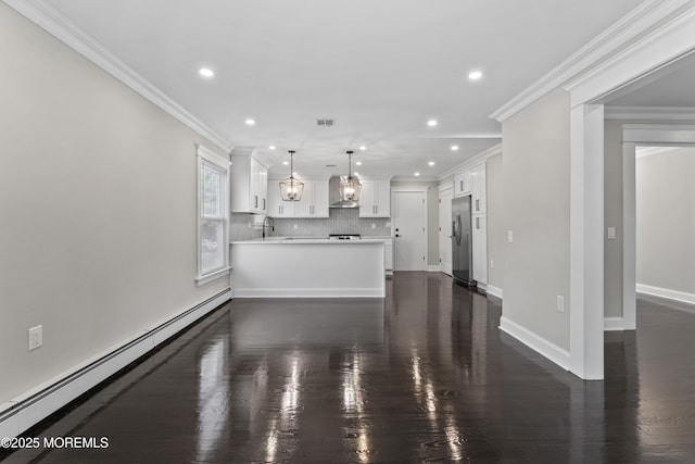 unfurnished living room with a sink, ornamental molding, baseboard heating, and recessed lighting