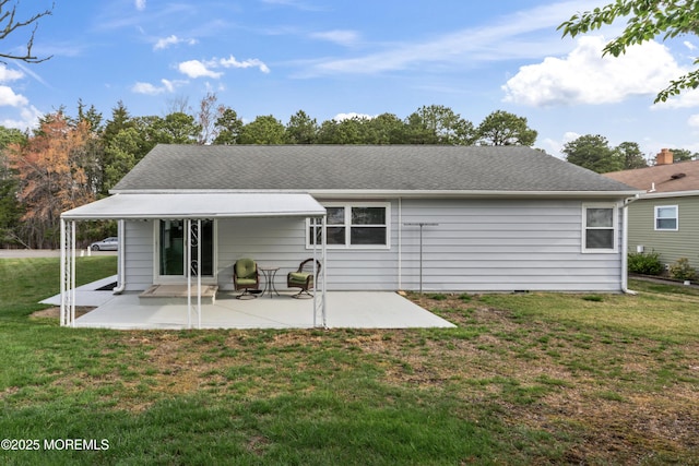 rear view of property with a patio and a yard