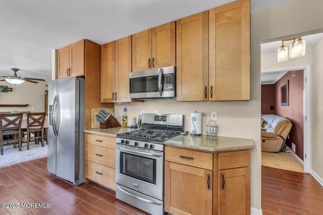 108 Longman St, Toms River, NJ 08753 - kitchen featuring light stone countertops, stainless steel appliances, dark wood-style flooring, baseboards, and a ceiling fan