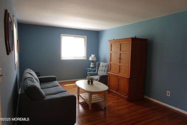 living area with baseboards and dark wood-style floors