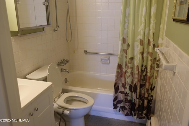 bathroom with toilet, tile walls, vanity, and shower / bath combo with shower curtain