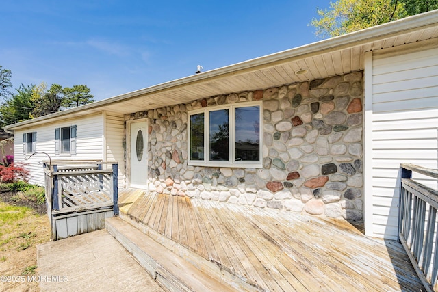 view of front of home featuring a deck and stone siding