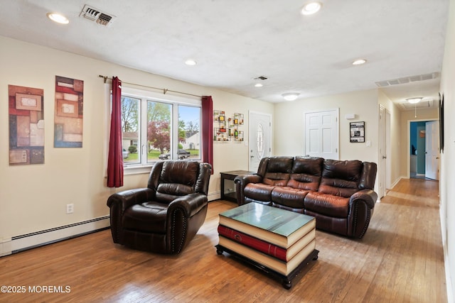 living area featuring wood-type flooring, recessed lighting, visible vents, and attic access