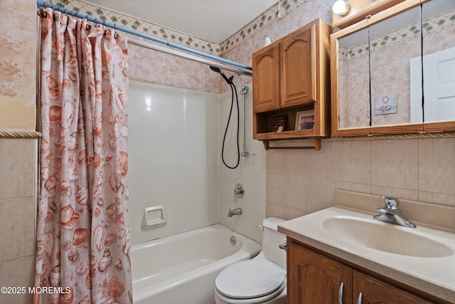 bathroom featuring vanity, shower / bathtub combination with curtain, toilet, and tile walls